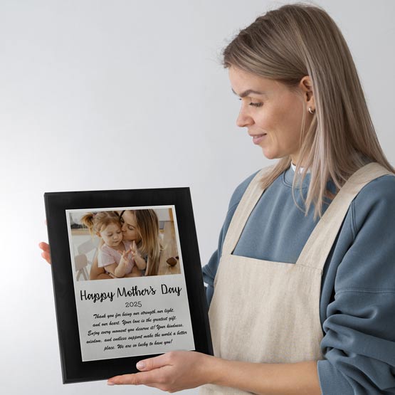 Young Mom Holding A Mother's Day Gift Plaque From Daughter In Appron.
