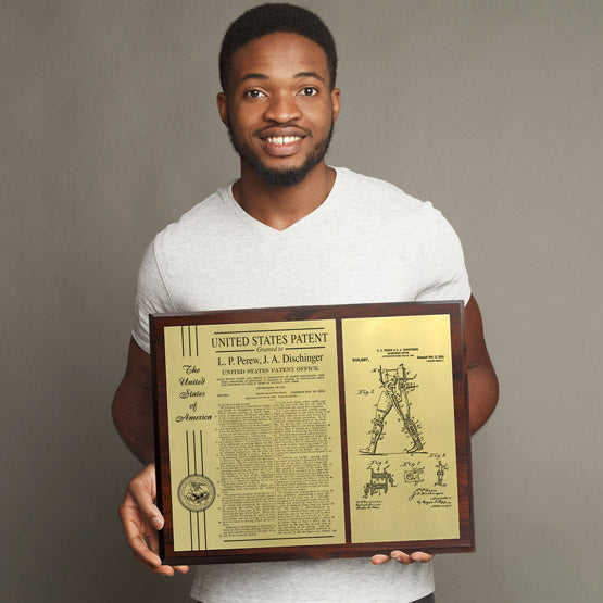 Young Man Holding A Custom Boardroom Patent Plaque With Gold Aluminum Metal.