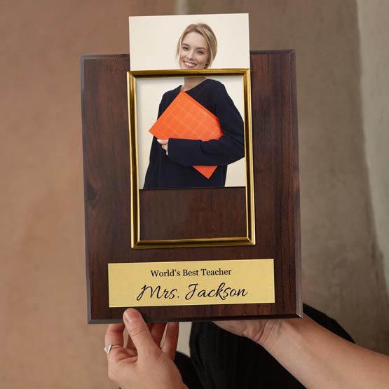 Woman Hands Putting Teacher Photo Into Custom Photo Frame Plaque With Gold Frame And Wood Board