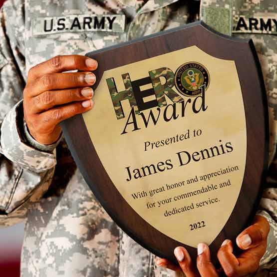 United States Soldier In Uniform Holding Up A Custom Shield Shaped Gold Aluminum Plaque Award For Military Hero