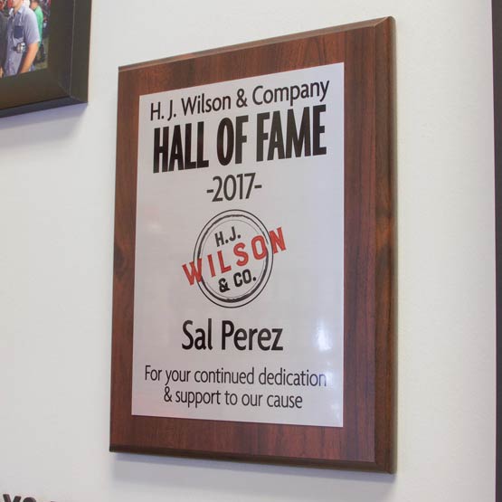 Custom Aluminum Plaque Award For Dedication With Hall Of Fame Heading And Names On Wood Board Hanging On Office Wall
