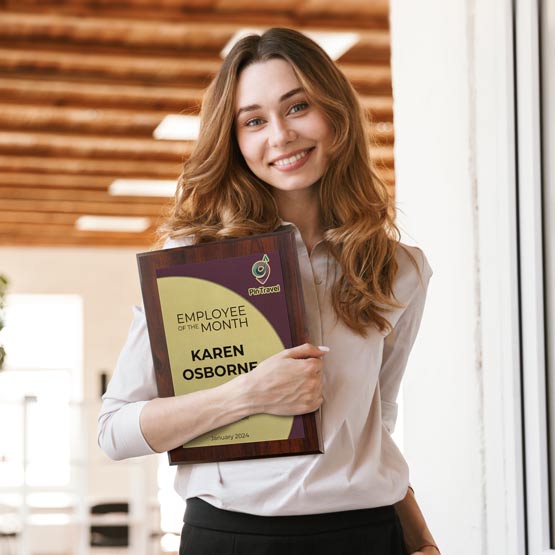 Happy Business Woman Holding An Aluminum Employee Of The Month Plaque In Doorway.