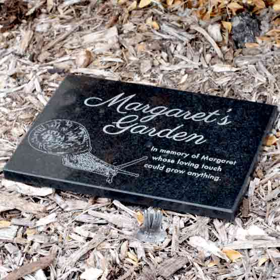 Custom Granite Plaque Laser Engraved With Snail Art And Margaret’s Garden Memorial Message Displayed In Mulch