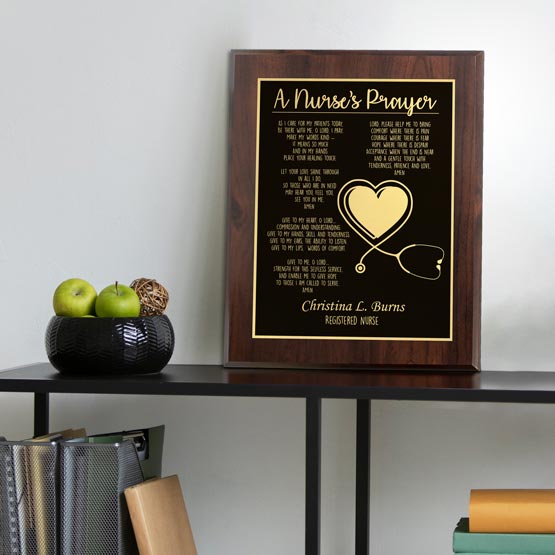 Custom Metal Plaque With Wood Board And Laser Engraved With Complete Nurse’s Prayer On A Black Bookshelf With Folders