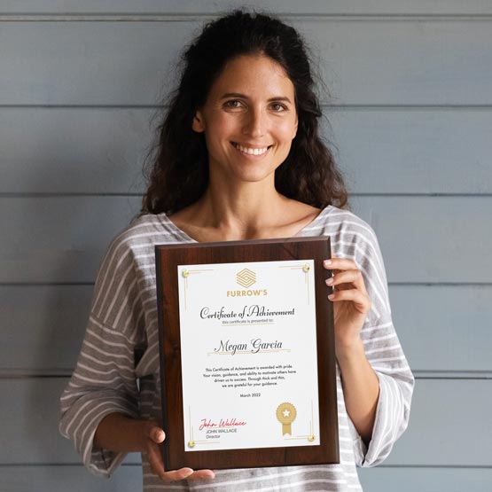 Happy Woman Holding Certificate Plaque Achievement Award With Wood Board And Plexiglass And Gold Tacks Nearby House Siding