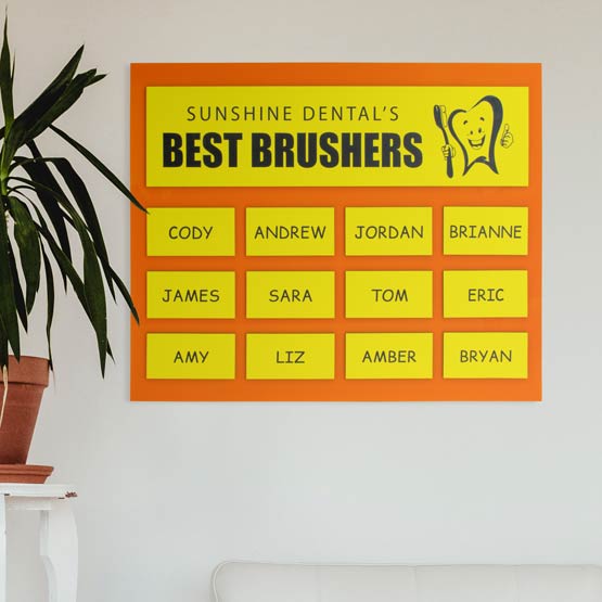 Perpetual Plaque With Orange Acrylic Board And Plastic Plates With Dentist Logo And Best Brushers Names On Office Wall