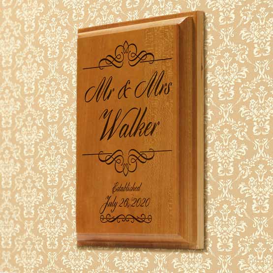 Solid Cherry Plaque Engraved With Marriage Titles And Family Name And Established Date Mounted On Wall With Floral Pattern