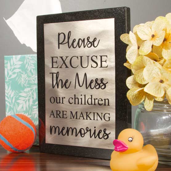 Titanium Plaque With Granite Board And Children Making Memories Message Freestanding On Shelf With Toys And Flowers