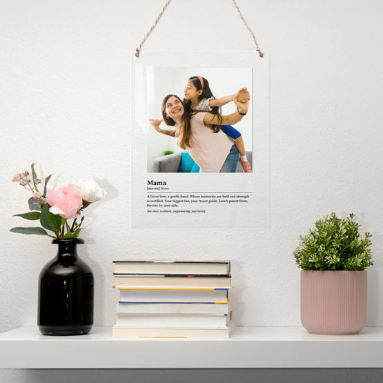 Acrylic Sign With Photo Of Mom With Daughter And Custom Mom Definition Hanging Via Twine Above Shelf With Books And Plants