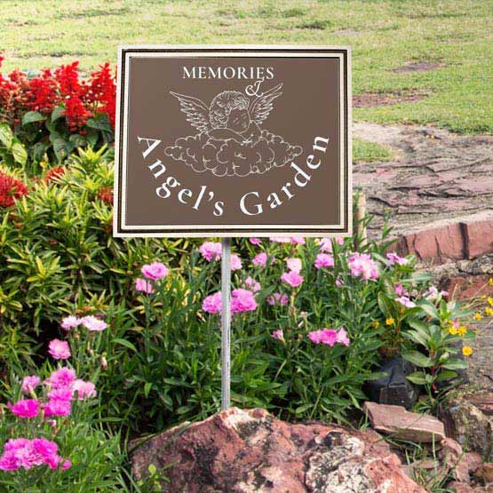 Bronze And Brown Cast Aluminum Sign With Angel Art And Angel’s Garden Memories Text Displayed In Flower Garden Via Stand