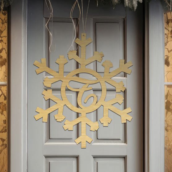 Custom Snowflake Cutout Bamboo Sign With Monogram Cutout Of The Letter F Hanging Via Holes And Twine On Front Door 
