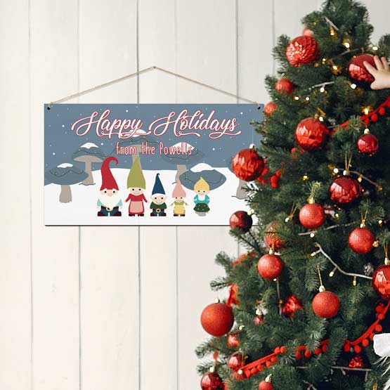 Full Color Bamboo Sign With Festive Gnome Family Art And Happy Holidays Message On Living Room Wall By Christmas Tree
