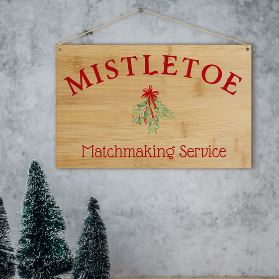 Full Color Bamboo Sign With Mistletoe Matchmaking Service Text And Mistletoe Art Hanging On Wall Via Twine Over Festive Decor