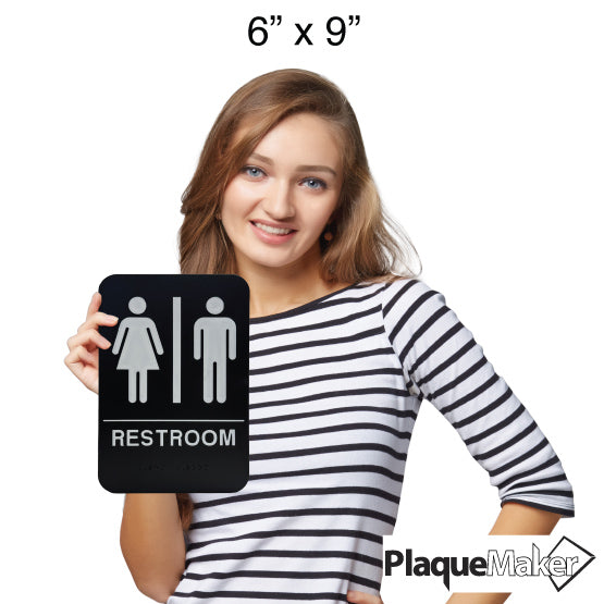 Size Guide Of Woman Holding Black And White Plastic Sign With Man And Woman Icons For Unisex Restrooms With Text And Braille