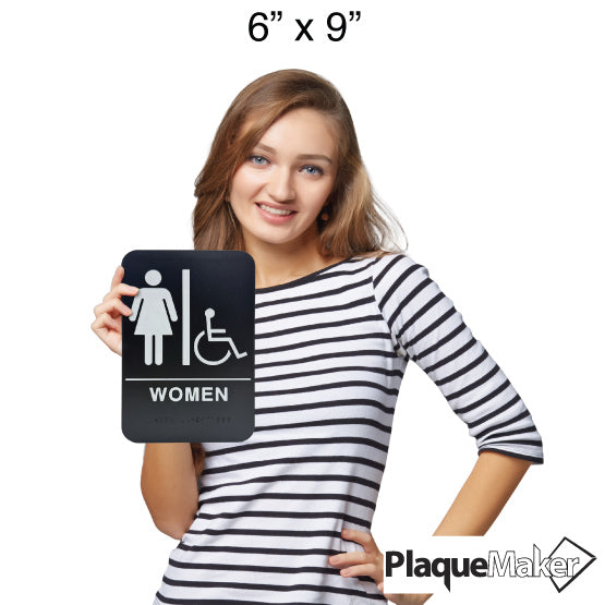 Size Guide Of Woman Holding Black And White Plastic Sign With Woman And Wheelchair Icons Above Woman Text With Braille