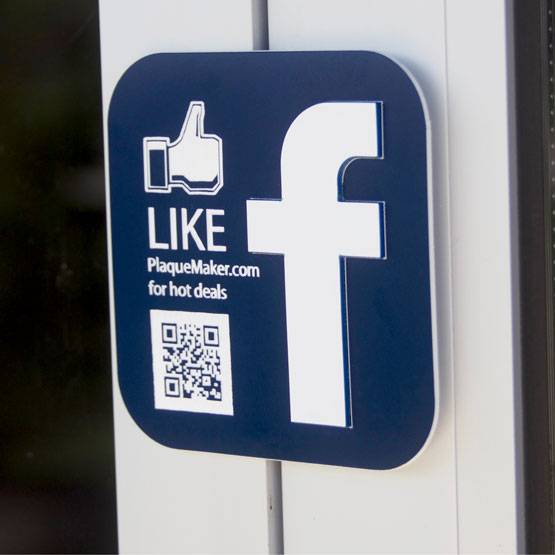 Blue Plastic Sign With Facebook Logo And Like Icon And Engraved With QR Code And Like Message Mounted On Business Door