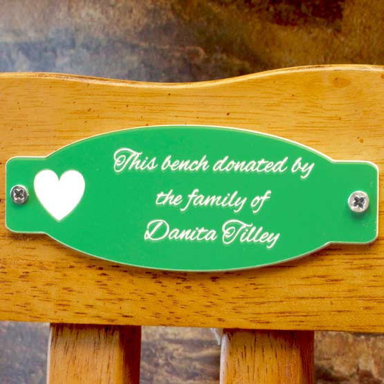 Green Plastic Label Engraved With Heart And This Bench Is Donated By The Family Of Danita Tilley Text Mounted On Wood Bench