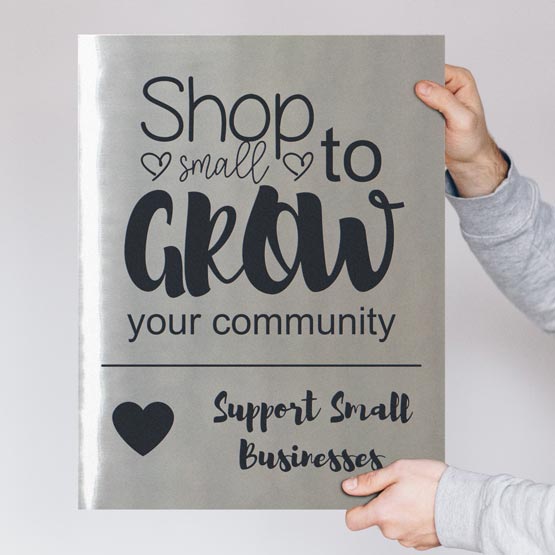 Hands Holding Stainless Steel Sign Laser Fused With Support Small Business Message And Heart Art Against White Background