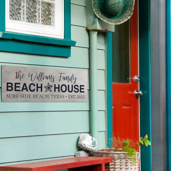 Rectangle Titanium Sign Laser Fused With Custom Family Name And Beach House Details Mounted On Blue House Exterior Wall