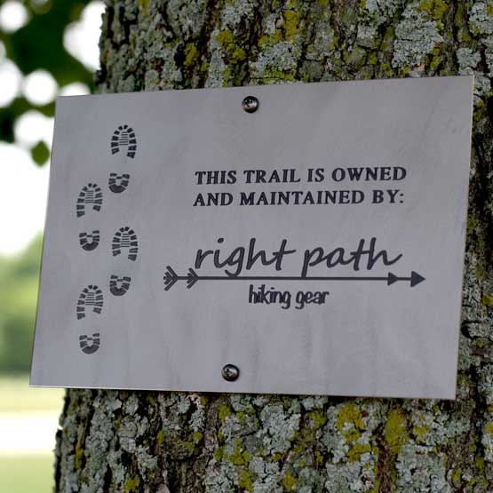 Custom Titanium Sign Laser Fused With Trail Details And Right Path Hiking Gear Logo And Footprint Art Mounted Onto Tree